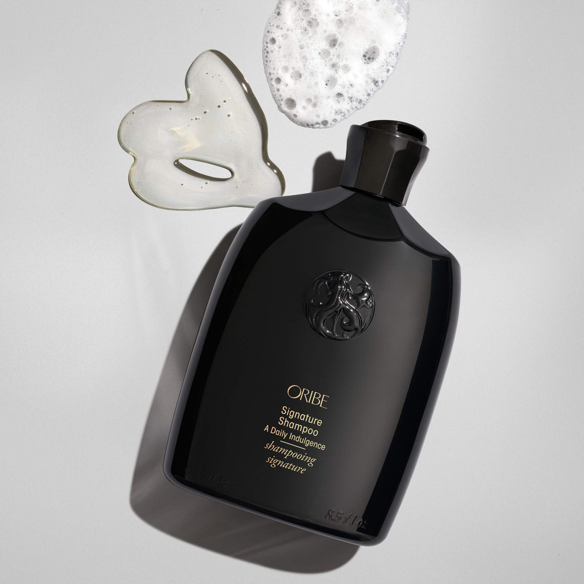 Oribe Signature Shampoo foam texture close-up showing brand hydration benefit