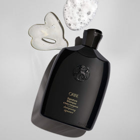 Oribe bottle on bathroom shelf suggesting luxury routine and visible care