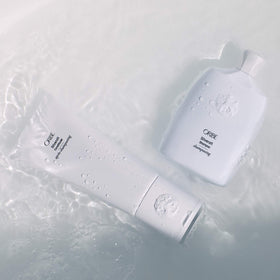 oribe conditioner being poured from bottle showing silky consistency for hydration