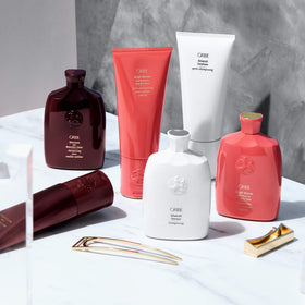 oribe bottle in hand for scale showing 6.8oz size and travel-friendly convenience