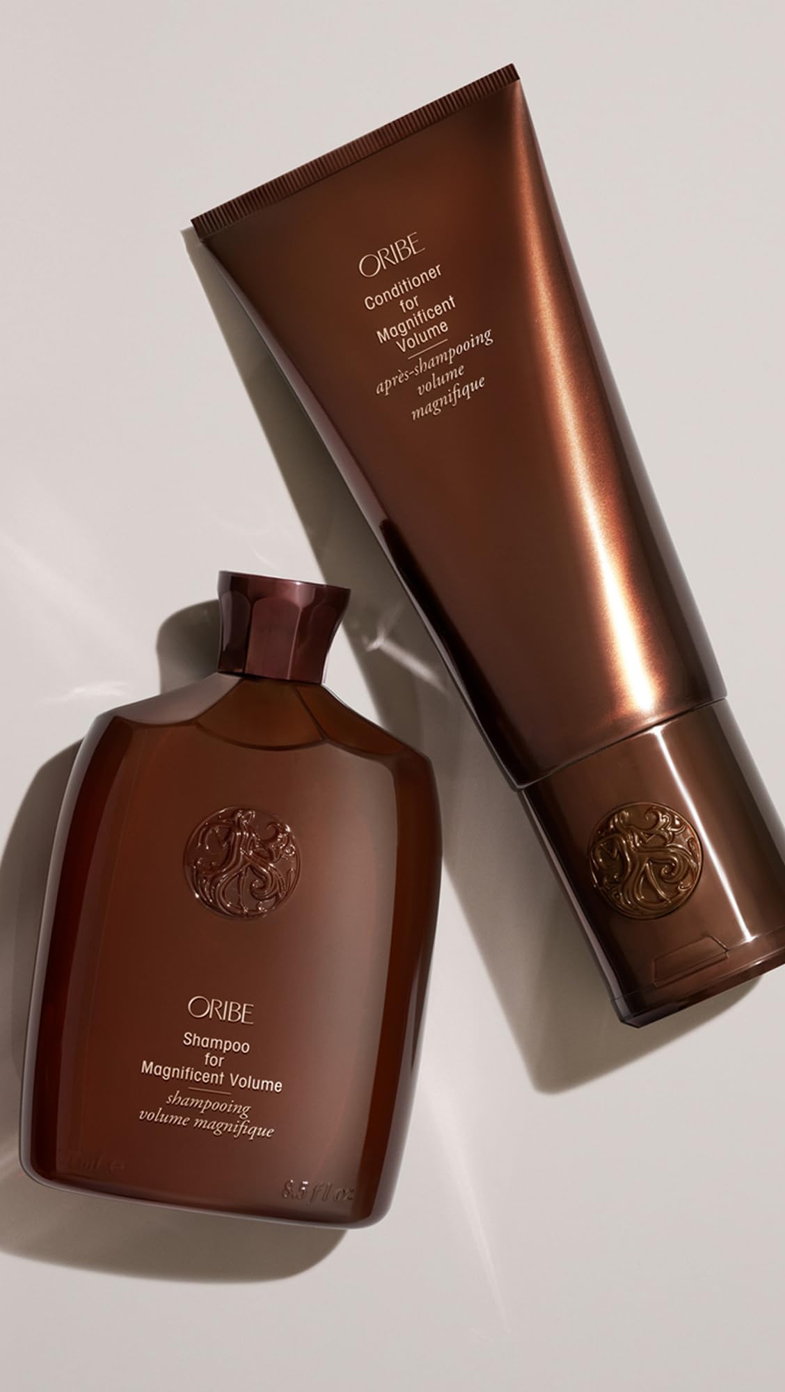Oribe 6.76 fl oz bottle in hand to show actual size