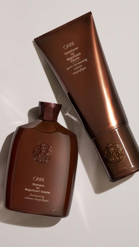 Oribe 6.76 fl oz bottle in hand to show actual size
