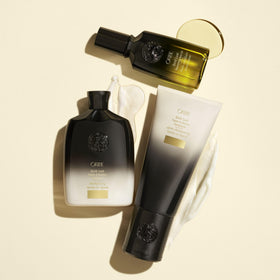 Oribe bottle held in hand to show 8.5 oz size and convenient daily use
