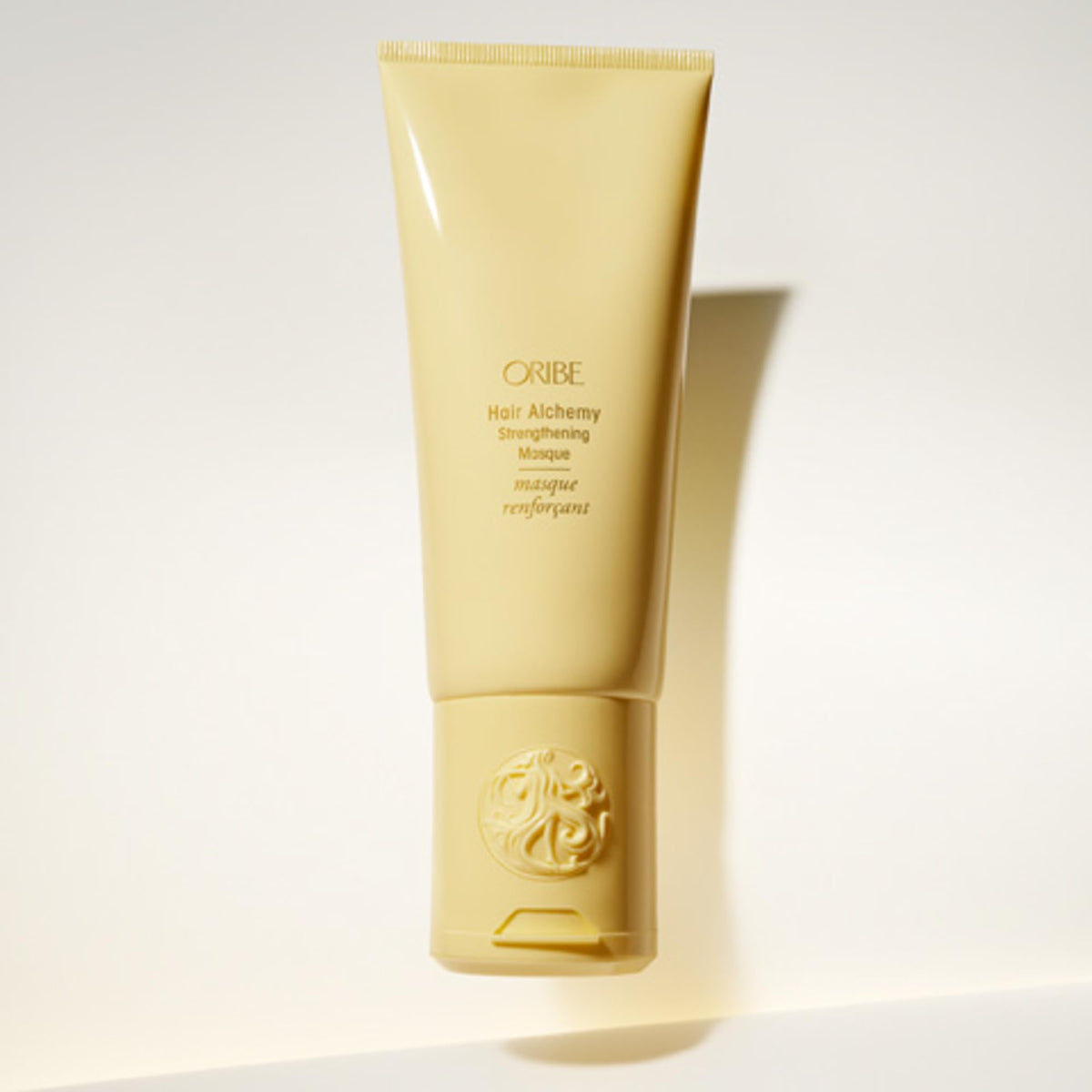 Oribe jar held in hand for size comparison showing portable luxury