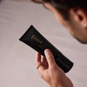 Oribe stylist using product in salon showing professional performance benefit