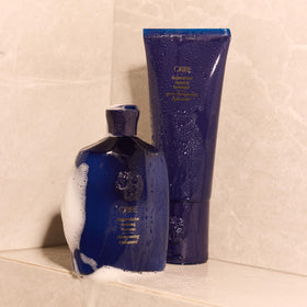 Oribe Supershine lifestyle image on model with glossy hair showing visible shine benefit