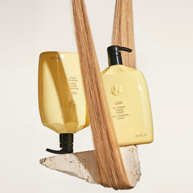 ORIBE pump dispensing shampoo into hand showing controlled application benefit