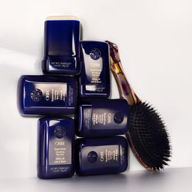 Oribe wax stick on a bathroom vanity in lifestyle scene suggesting daily use