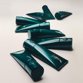 Oribe applied to damp hair showing enhanced curl definition and frizz control