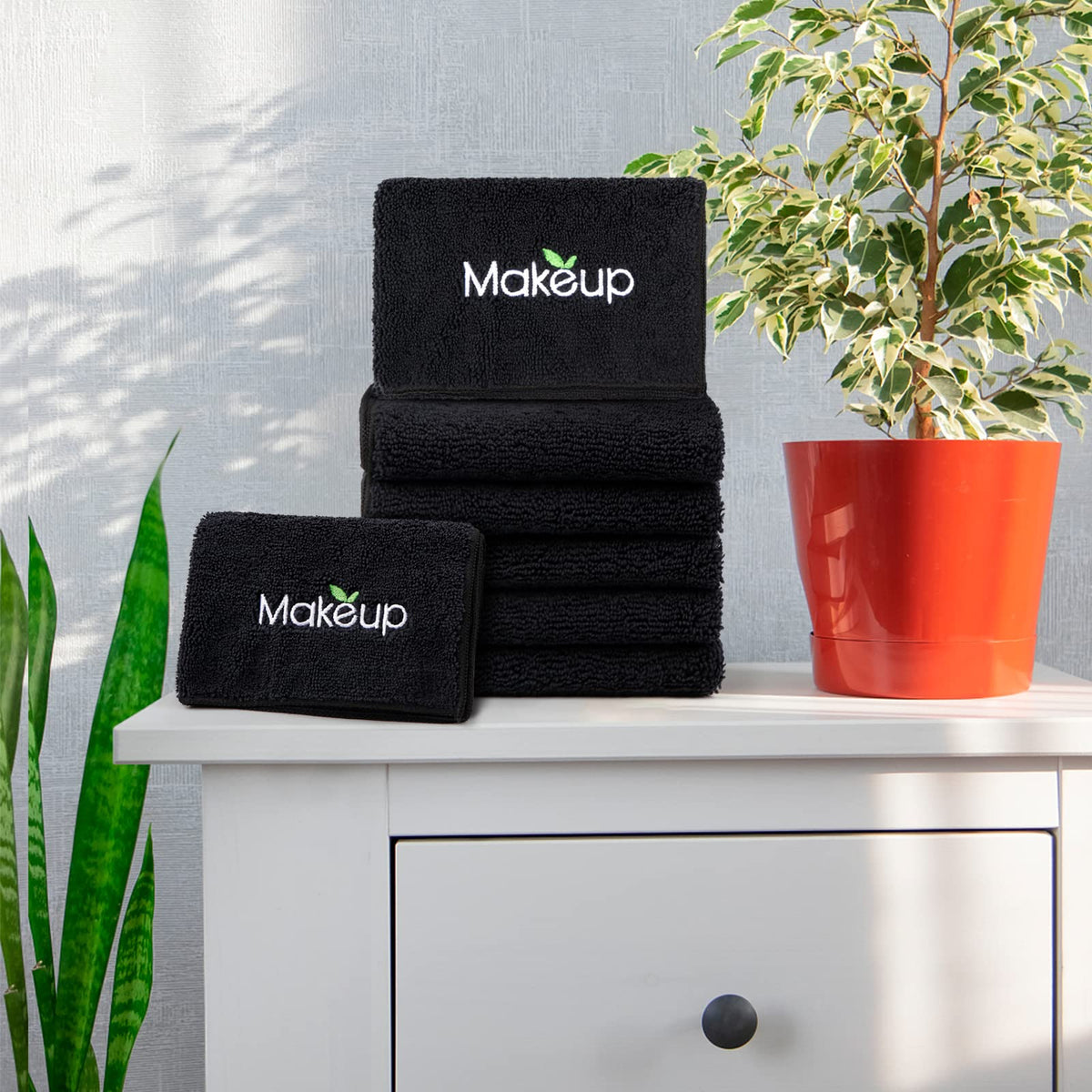 Orighty stacked towels in bathroom setting suggesting neat storage