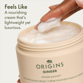 Origins tub next to hand for scale showing travel-friendly 6.7 fl oz benefit