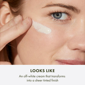 Origins GinZing swatch on skin displaying sheer tint and dewy glow for even tone