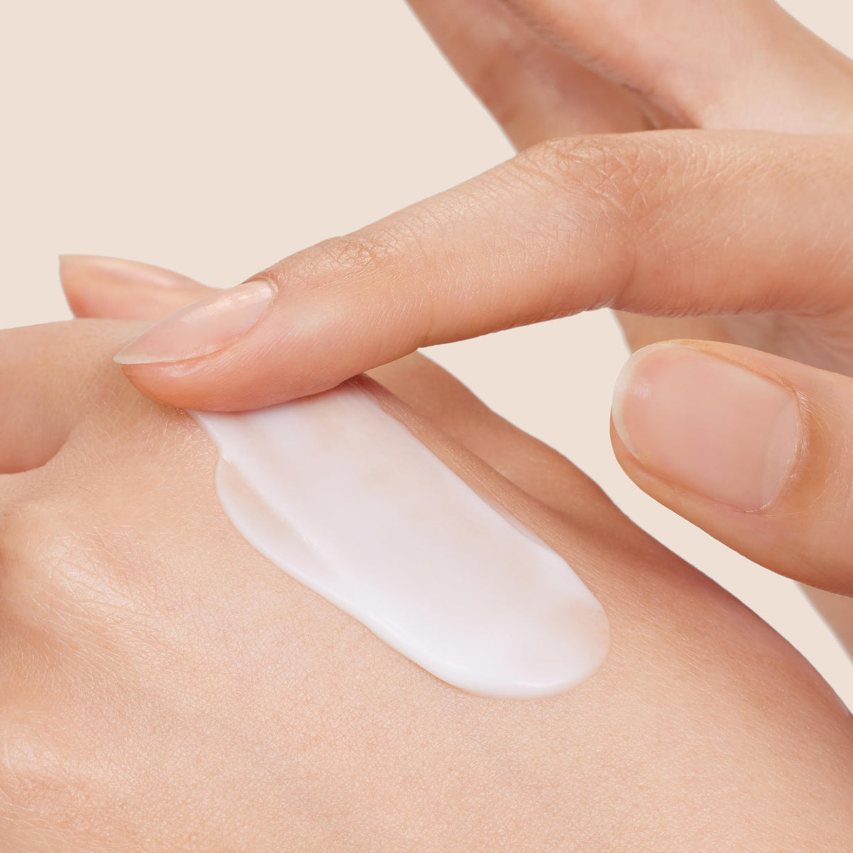 Origins hand cream texture closeup on fingertip demonstrating quick-absorb benefit
