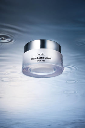 ORISIA HydraLactis 50ml next to ruler showing compact travel-friendly benefit