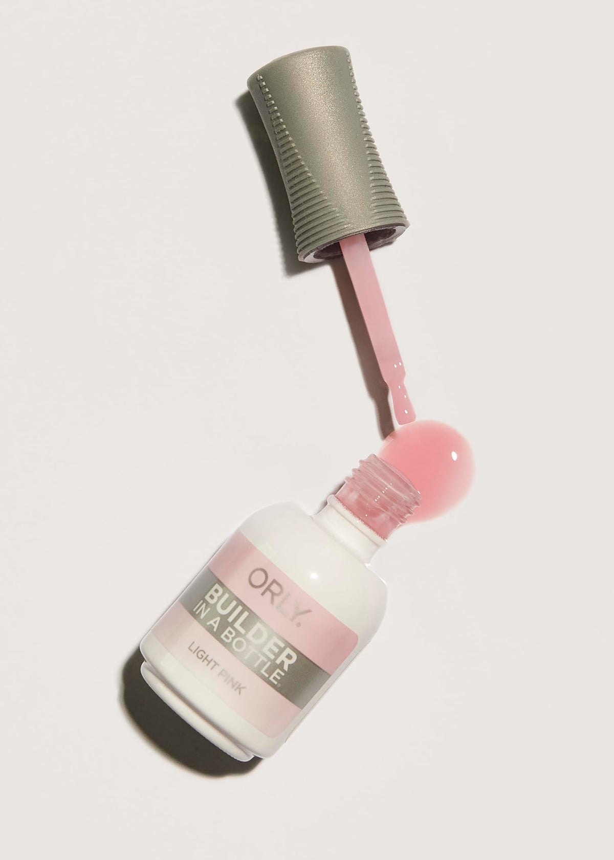 Orly GELFX Light Pink swatches on nail wheel showing buildable coverage benefits