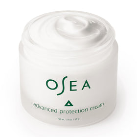 OSEA 1oz jar next to a coin for scale, communicates travel-friendly size