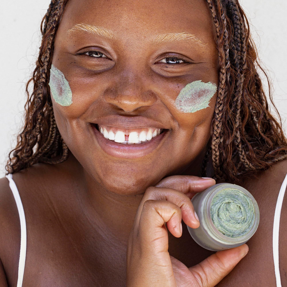 OSEA scrub applied on cheek demonstrating gentle massage and pore cleansing benefit