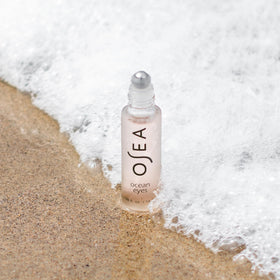 OSEA product next to a coin showing compact size and travel-friendly benefit