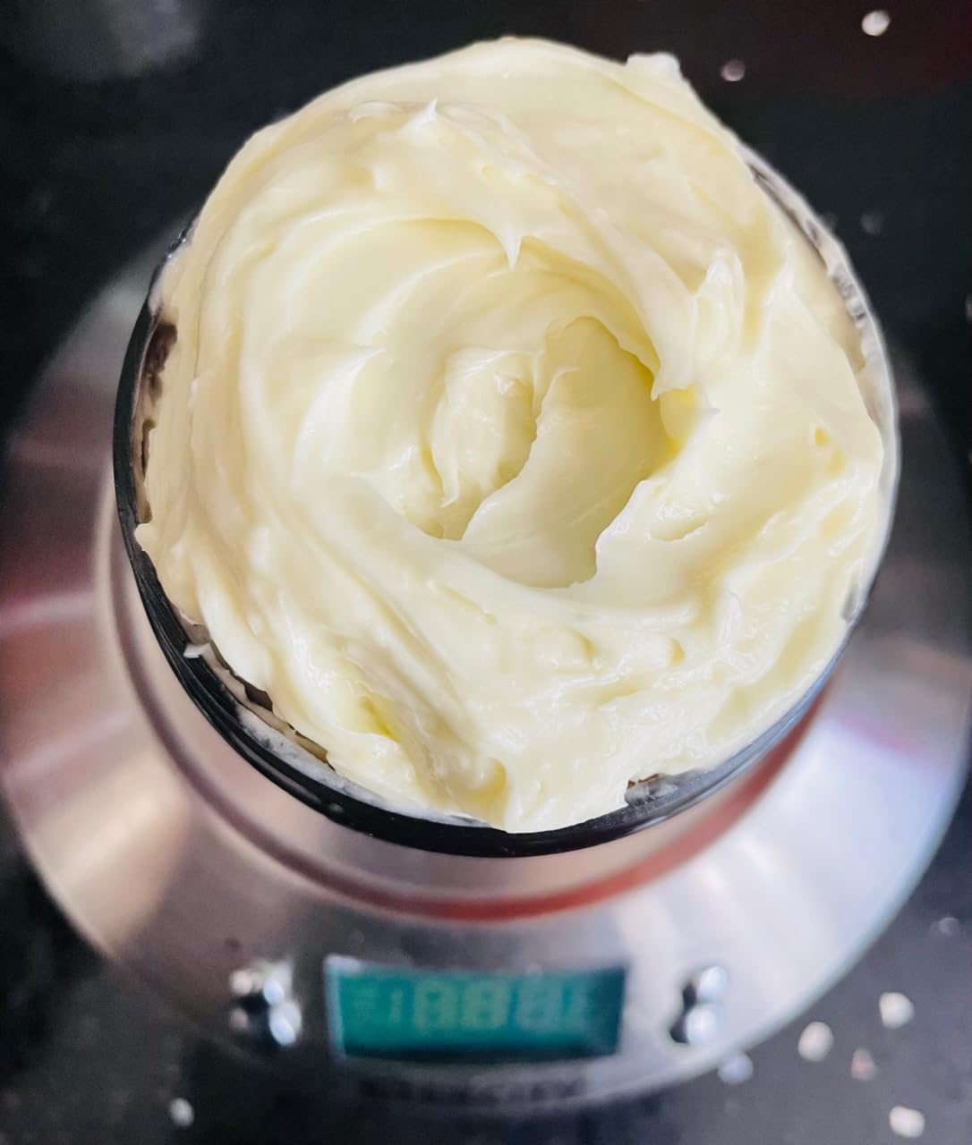 Oslove Organics closeup of mango butter texture revealing creamy granules