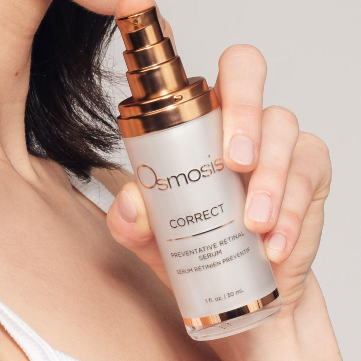 OSMOSIS bottle next to coin for scale showing one fluid ounce travel-friendly benefit