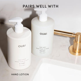 OUAI bottle staged in bathroom setting conveys luxe routine benefit