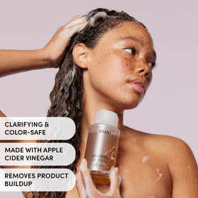 OUAI detox shampoo close-up formula with apple cider vinegar droplets for gentle exfoliation