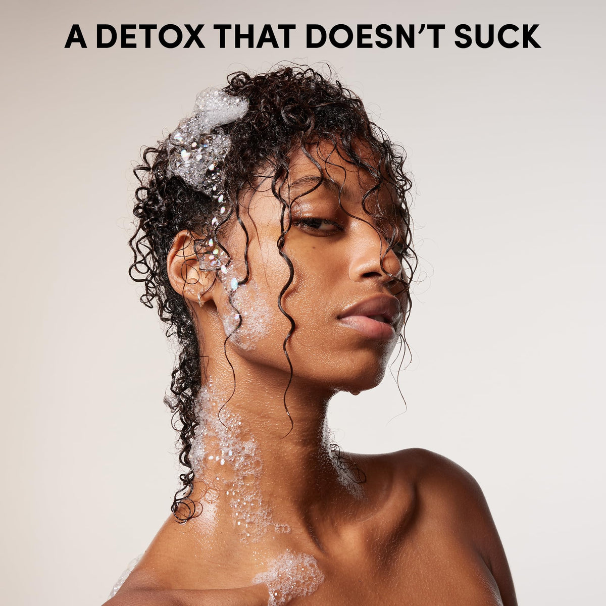 OUAI detox shampoo scent and packaging staged for lifestyle appeal and premium feel