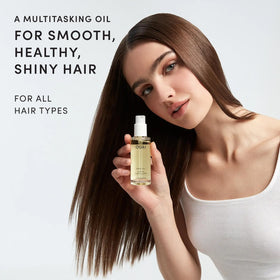 OUAI full-size hair oil bottle displayed upright for scale