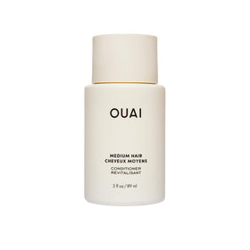 OUAI medium conditioner front packaging showing bottle and logo for brand recognition and travel convenience