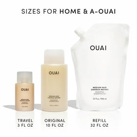 OUAI medium shampoo on bathroom counter with candle, lifestyle mood of fresh, scented routine