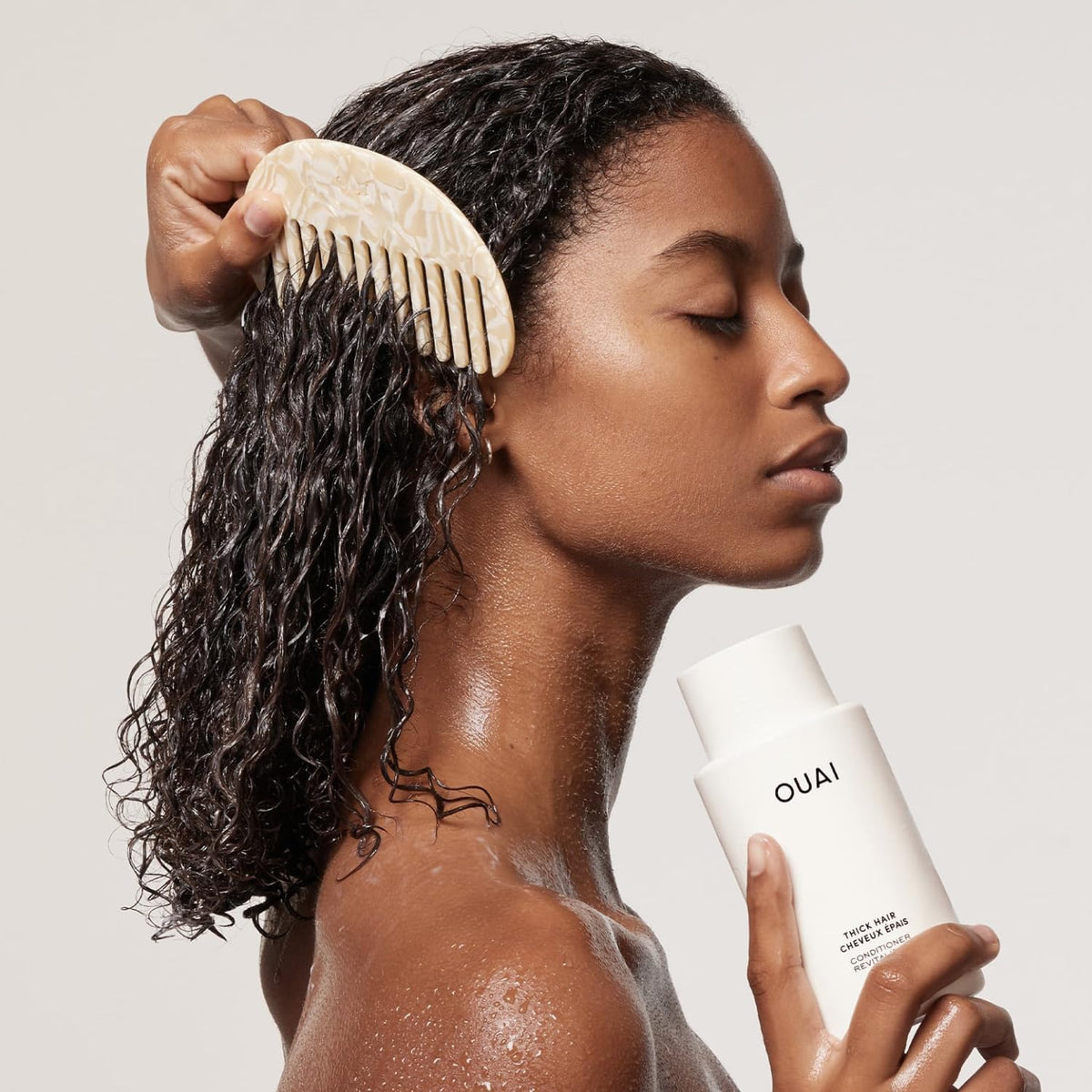 OUAI creamy conditioner texture close-up demonstrating rich moisturizing slip