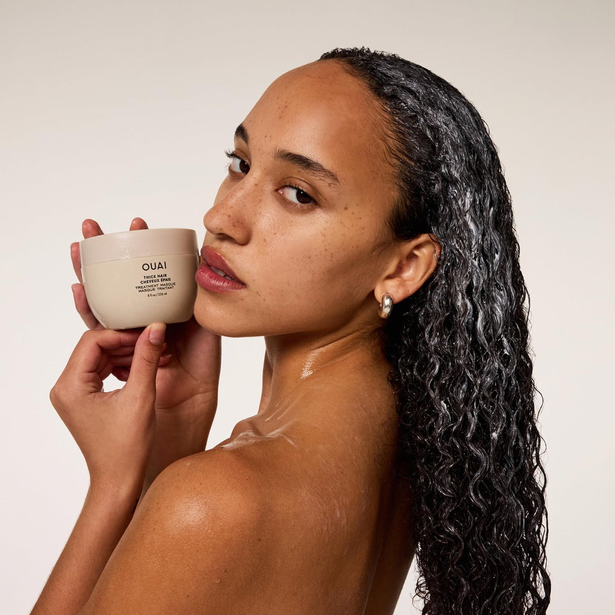 OUAI overnight bun on damp hair showing deep conditioning and time-release repair