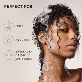 OUAI thick shampoo lathering in shower reducing tangles during wash