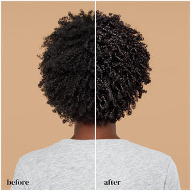 Ouidad applying mask to wet hair with wide-tooth comb for even distribution and detangling