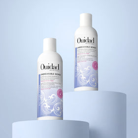 Ouidad bottle on bathroom shelf staged for comforting daily routine