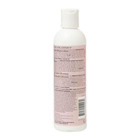 Ouidad conditioner on a bathroom shelf styled for everyday curl routine