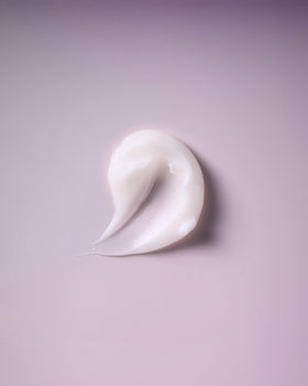 Ouidad product being poured onto palm to show creamy gel consistency and control