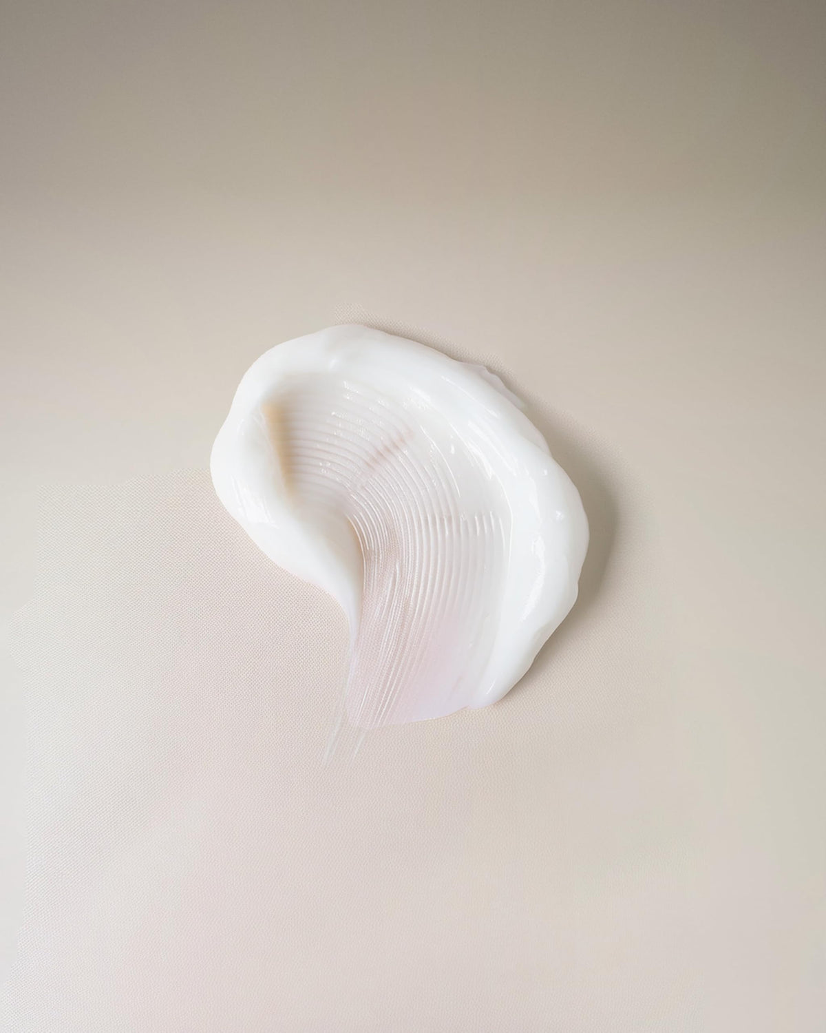 Ouidad texture close-up of cream highlighting lightweight, fast-absorbing formula benefit
