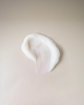 Ouidad texture close-up of cream highlighting lightweight, fast-absorbing formula benefit