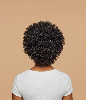 Ouidad product being applied to wet coils for easier detangling
