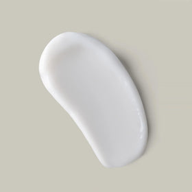 Ouidad hand applying curl butter demonstrating easy application and definition