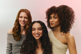 Ouidad label with sericin and ingredient callouts highlighting anti-frizz protection