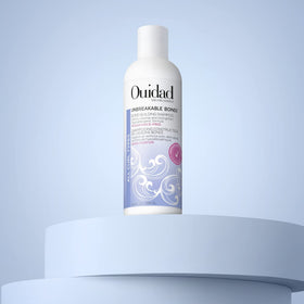 Ouidad lather on curly hair during wash showing improved curl definition