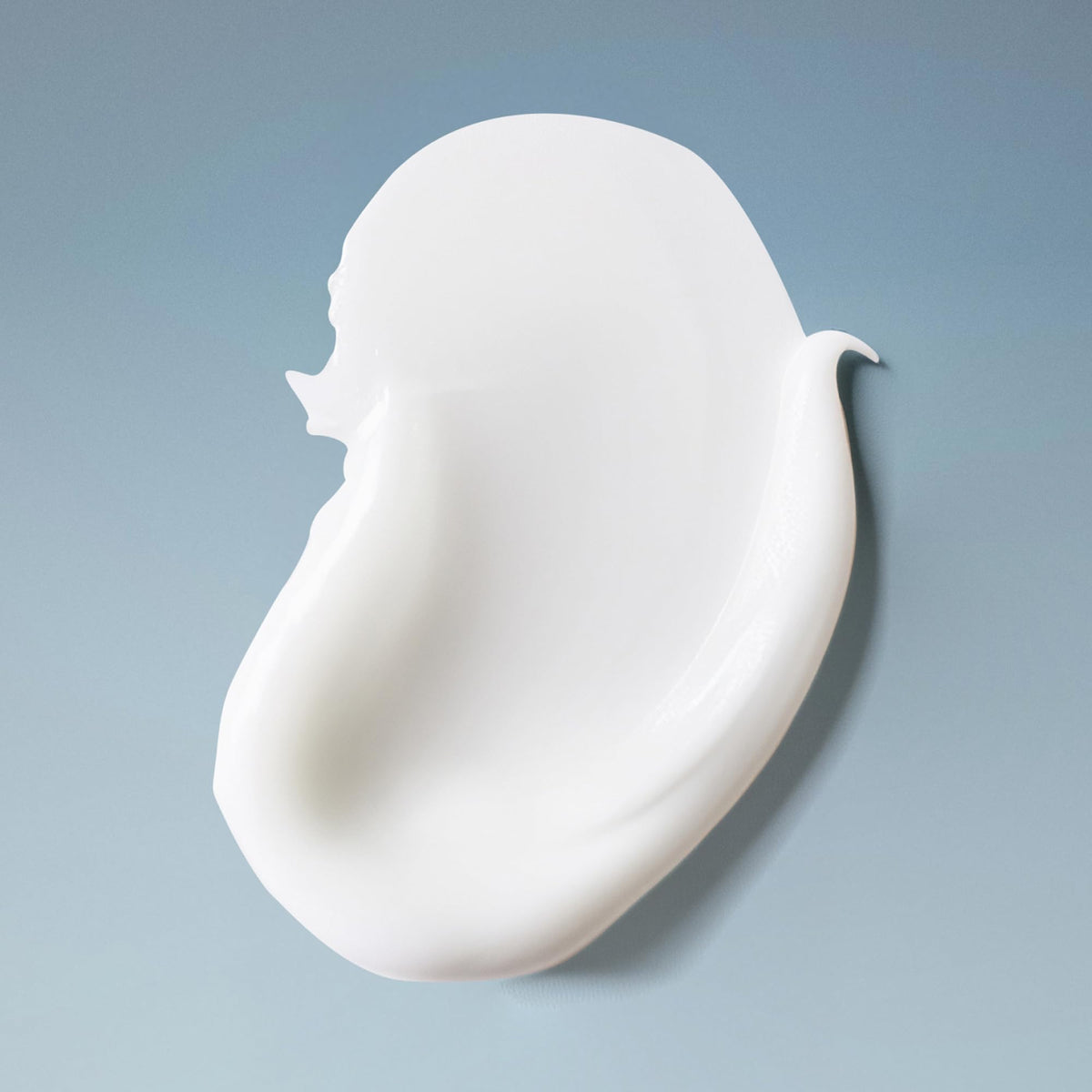Product in shower on wet curly hair illustrating gentle cleansing and softness