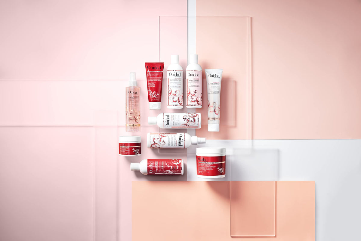 Ouidad balm next to hand for scale showing pocket-sized convenience