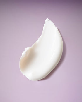 Ouidad creamy deep conditioner texture close-up displaying rich slip and moisture