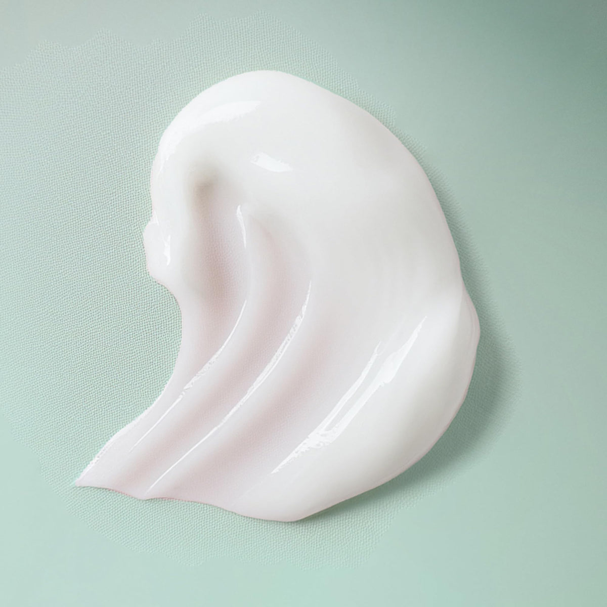 Ouidad product in hand applying to hair for easy distribution and lightweight feel