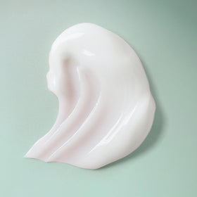 Ouidad product in hand applying to hair for easy distribution and lightweight feel