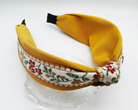 OUTVIE close-up of lace embroidery and floral detail, highlights handcrafted texture