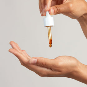 PAI SKINCARE applying oil to back of hand, demonstrates absorption and softening benefit
